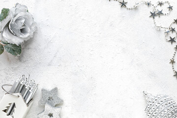 New Year's composition. Christmas white and silver decorations on a white background. Flat lay, top view, copy space