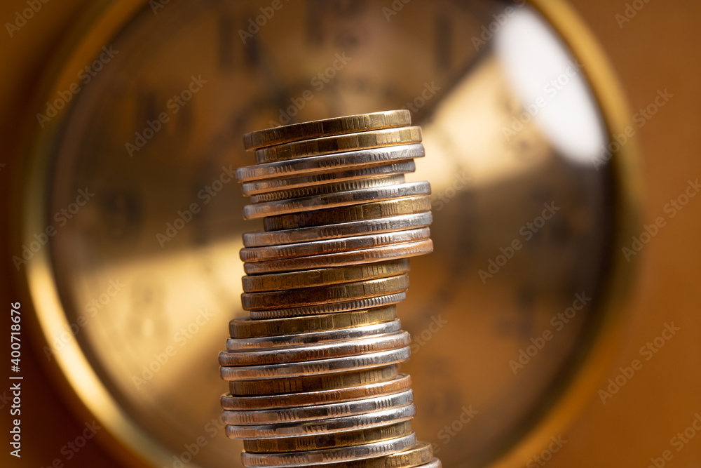 Aufkleber stack of coins on the background of the clock. money time concept