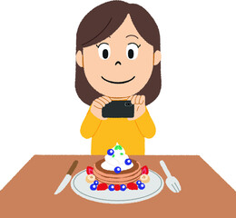 パンケーキをSNSに投稿する女性