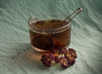 large cup of black tea with oregano
