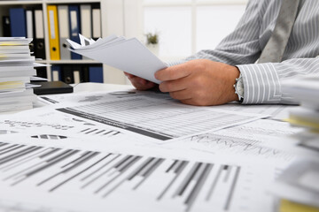 business concept - businessman working with reports in office, table and workspace close view,...