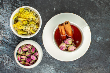 top view of herbal tea with dry flowers on grey background