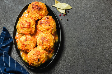 Chicken and rice Italian meatballs casserole in cast iron skillet. Top view, space for text.