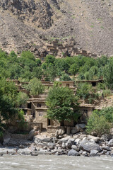 Vertical view of remote traditional Afghan village on mountain side along the Panj river taken from Darvaz district in Gorno-Badakshan, Tajikistan Pamir