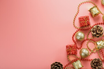 Christmas composition of decorations and Christmas toys on a pink background