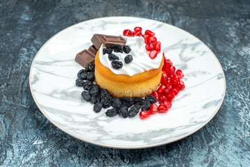 front view little delicious cake with chocolate and raisins on light-dark background sugar cookie sweet biscuit dessert