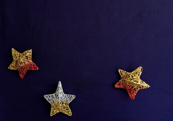 Three golden stars on navy background