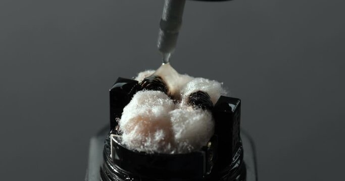 A person fills his vape with a special liquid