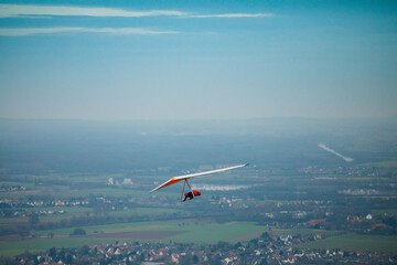 Hang glider in the air on a sunny day.