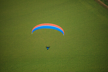 Paraglider flying in summer day. Extreme sport. Adrenalin. Flight.