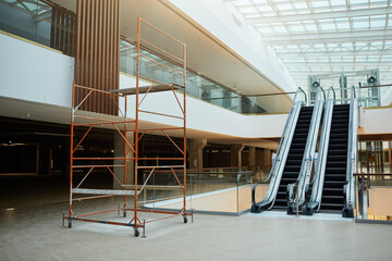Background image of escalator in shopping mall or office building under construction, copy space