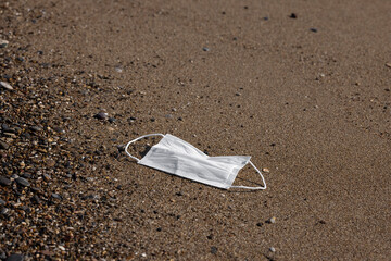 a dirty mask thrown on the beach