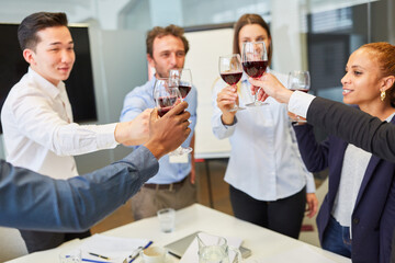 Business people celebrating with a red wine