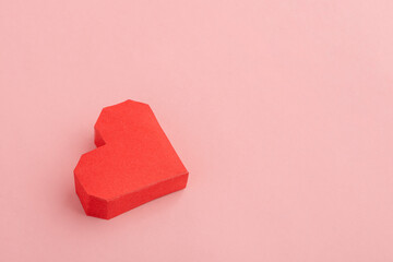 Red paper heart on pink background, top view