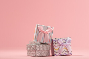 Pile of little gift boxes on pink background