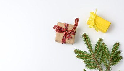 gift boxes wrapped in brown paper and tied with a ribbon on a white background