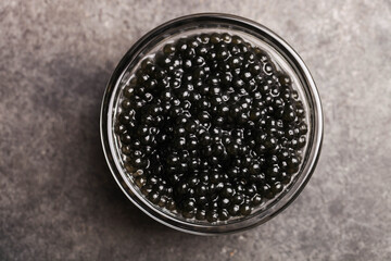 Obraz na płótnie Canvas Black sturgeon caviar in a glass bowl