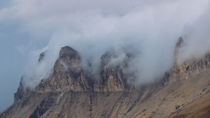 Mystical mountain peaks in the fog, haze