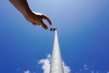 hand gesturing in the blue sky