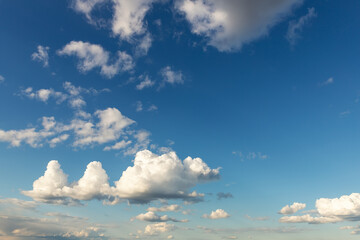 Weird unusual animal silhouette fantasy dream cloudscape on beautiful evening blue sky background. Fluffy cumulus cloud hills floating in clear skyline horizon. Natural sky panorama