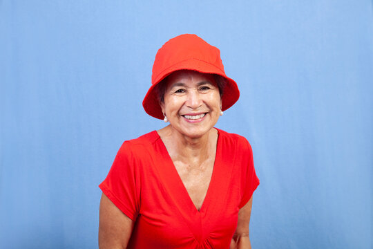 Senior Hispanic Woman In A Red Hat.