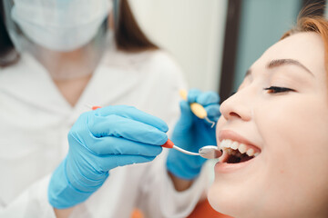 Fototapeta premium Portrait of caucasian girl undergoing dental examination at the dentist