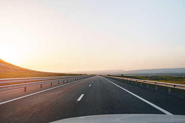 Empty highway at dawn, view from driver's perspective