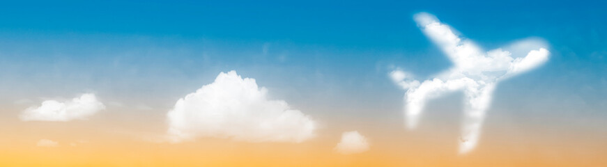 Fototapeta na wymiar Plane symbol in clouds at sunset concept for tropical holiday panoramic