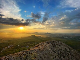 Bright sunset overlooking the mountains. Beautiful sky with clouds