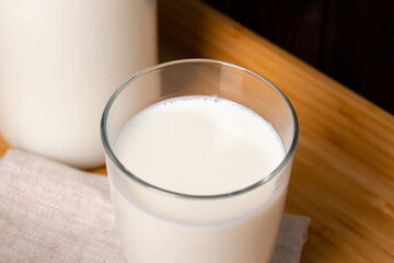 Glass cup of milk on table close up