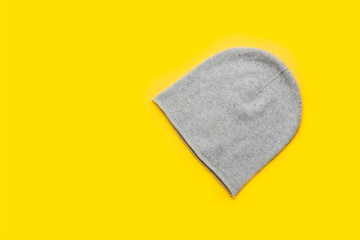 Gray unisex cashmere beanie on yellow background, trendy colors 2021, Top View, Copy Space
