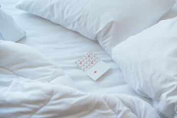 Be my valentine, valentine's day card on the bed on the sheet. Mockup for text.