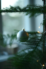 christmas ornaments in silver color  hanging on christmas tree