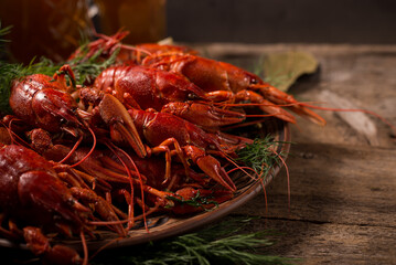 Crayfish boiled on a dish with dill spices and lemon.