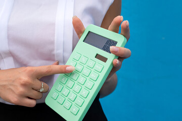 Pretty business woman hold calculator