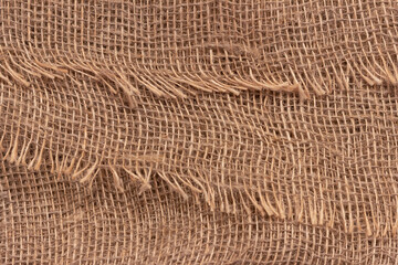 The texture of an uneven crumpled, roughly woven burlap.