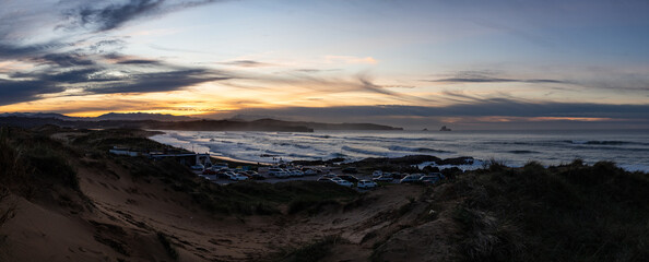 Fototapeta na wymiar Panoramic landscape at sunset in the sand dunes of Valdearenas Beach in Liencres, Cantabria.