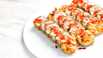 Traditional Japanese sushi rolls on a white plate. Top view. Asian food. On a white background.