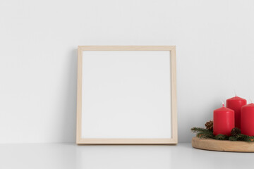 Wooden square frame mockup with candles. Christmas decoration