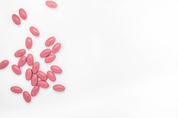 Red tablets Placed on white background Medicines help keep the body normal.