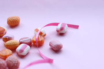 mixed candies on pink background