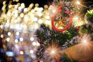 Obraz na płótnie Canvas Star decoration on christmas tree on abstract bokeh festive background. Merry Christmas happiness party concept
