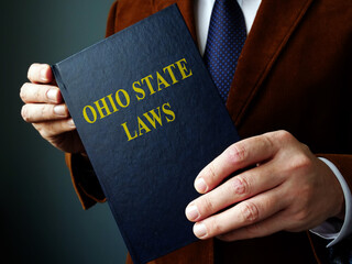Ohio state law concept. The man is holding a book.