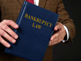 Bankruptcy law book in the hands of a lawyer.