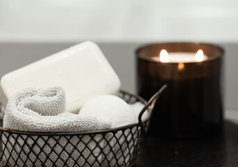 Cozy spa composition with bath accessories in a basket close up.