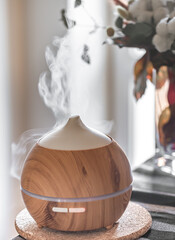 Modern oil aroma diffuser close up on a blurred background.