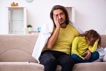 Small girl looking after her sick father