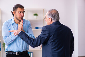 Old boss and his young assistant in the office