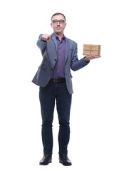 Cheerful handsome well-dressed young man in glasses holding gift box and looking at camera with smile