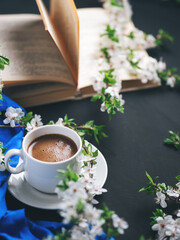Obraz na płótnie Canvas Spring time, white cup of coffee, cherry blossoms, old book